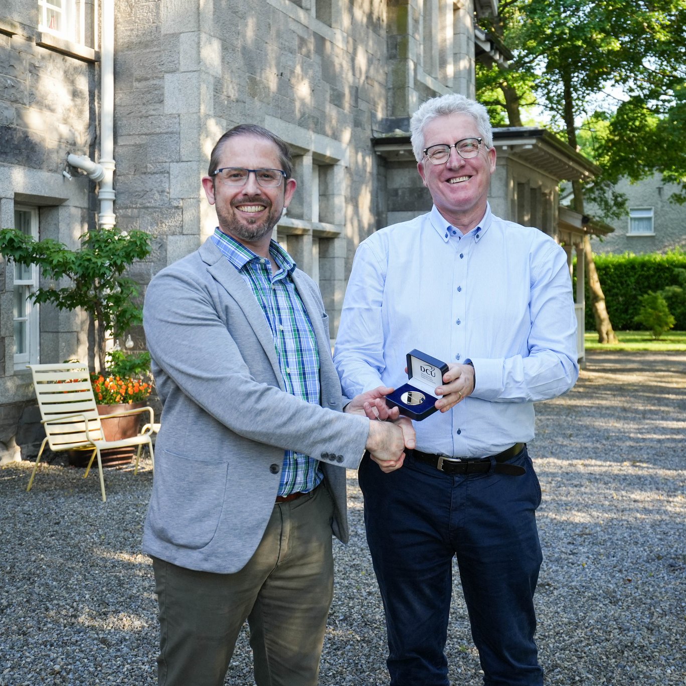Dr James Brunton receiving a DCU Alumni Council service medal from Prof Dáire Keogh