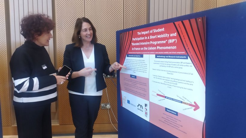 Presenting a poster displaying a PhD student's thesis